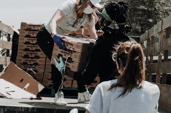 Volunteers unloading boxes off a truck