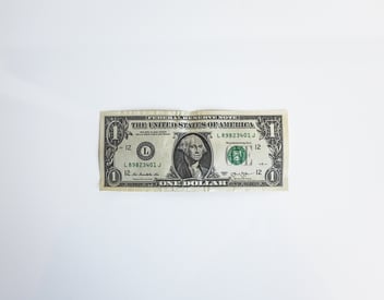 crumpled US $1 bill on white background 